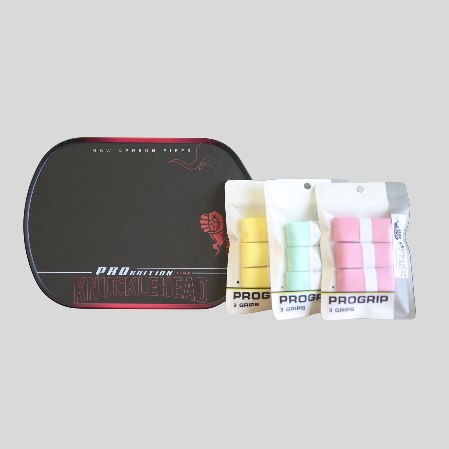 A black Pro Grip Knucklehead case with red trim, shown alongside three packaged sets of finger grips in yellow, mint green, and pink on a light gray background.